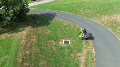 Young-hispanic-woman-mowing-lawn-on-tractor-cutter