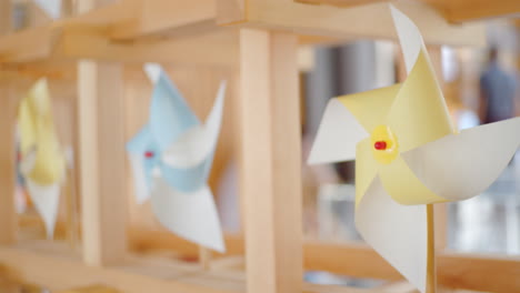 colorful paper pinwheels on a wooden display