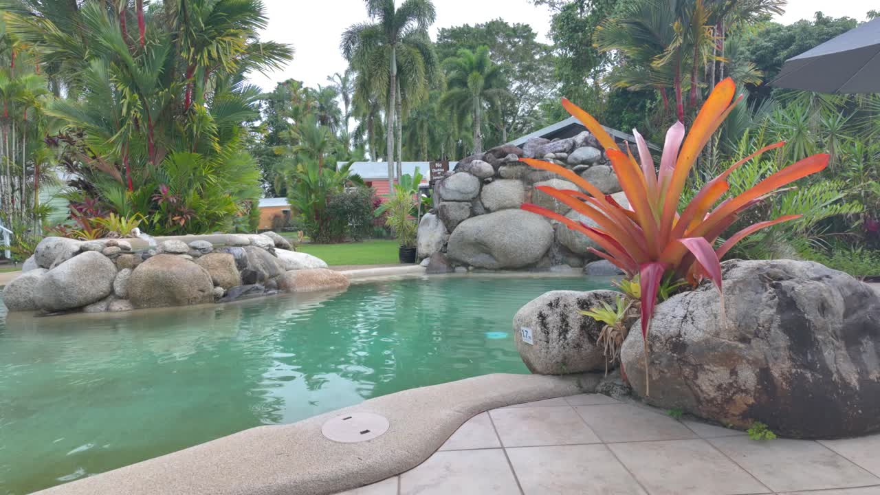 4K Video of beautiful swimming pool with waterfalls in a holiday resort in North Queensland in Australia