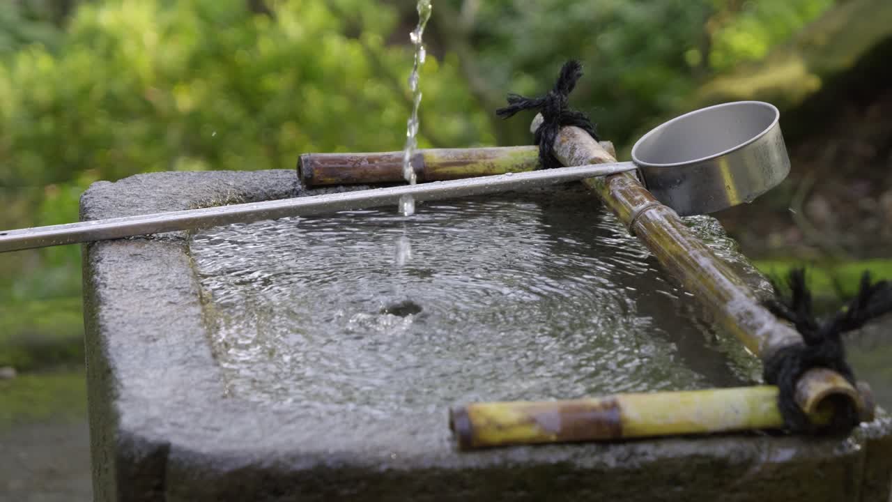 Chozu ladle at Japanese shrine. Slow cinematic slider view