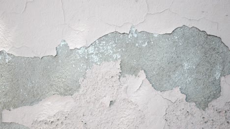 close-up of a cracked and peeling pink wall