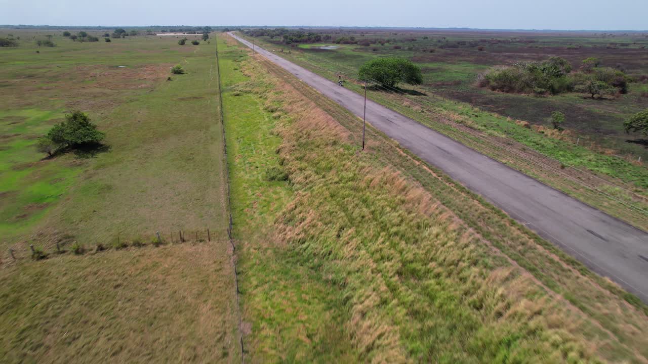 Drone tracking along empty road through lush natural landscape, Apure, Venezuela