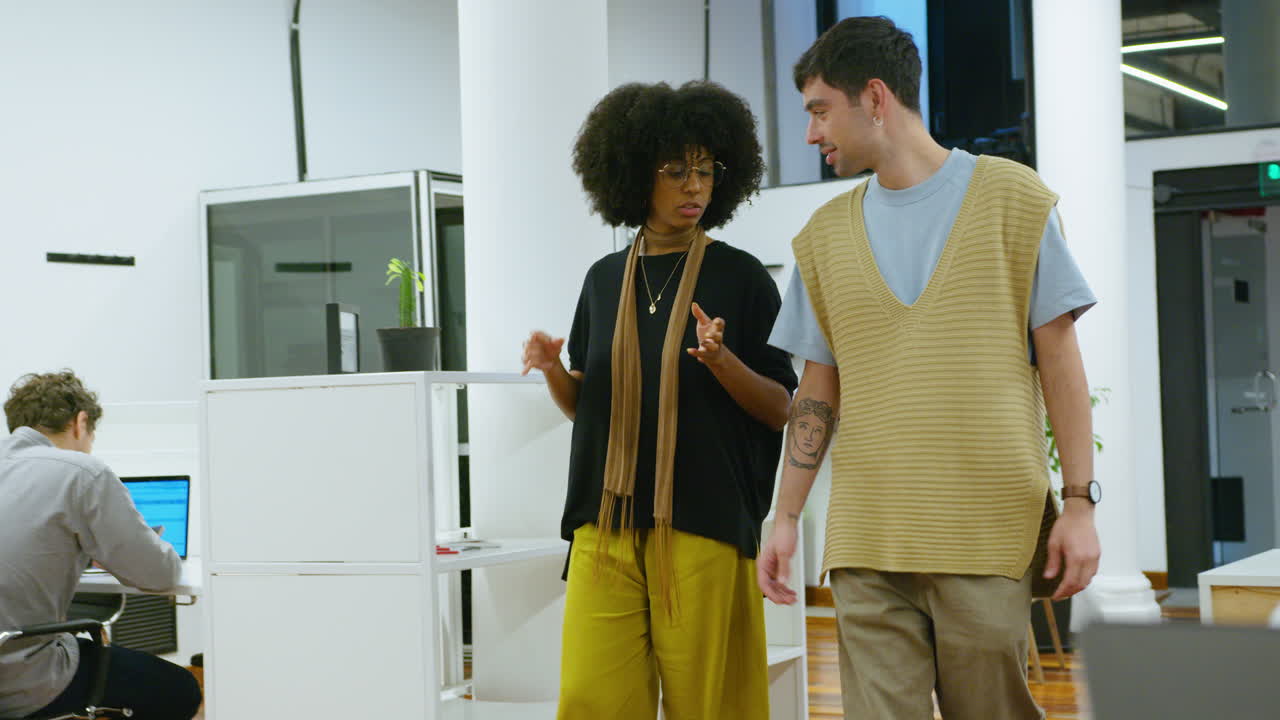 Coworkers Walking Through Office and Speaking during Working Day