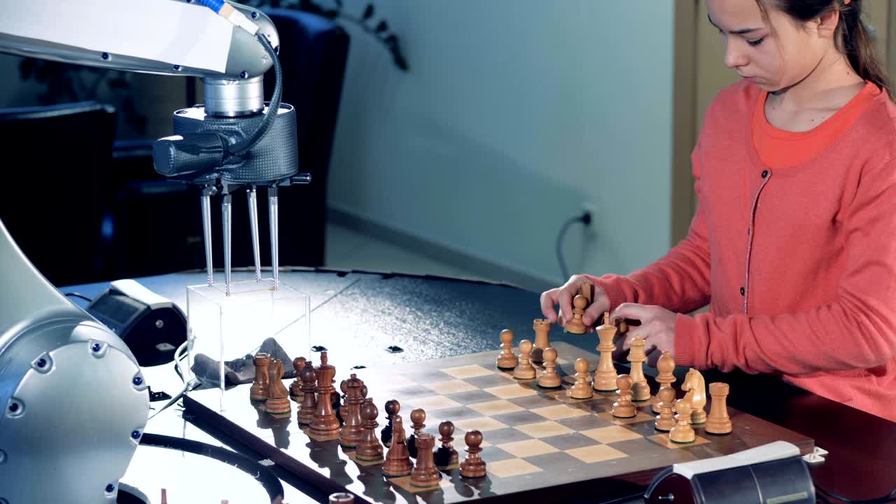 una niña preparando un tablero de ajedrez para jugar al ajedrez con un robot.