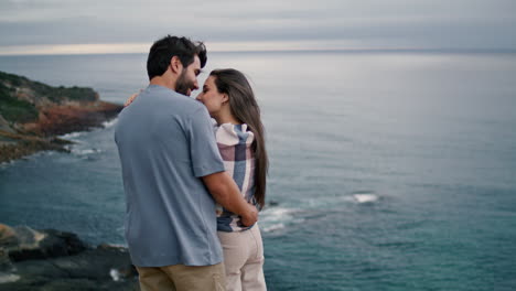 Romantic-family-standing-beach-in-front-evening-seascape.-Loving-couple-hugging.