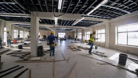 Wide-angle shot of a construction site with workers in hard hats, capturing the dynamic process