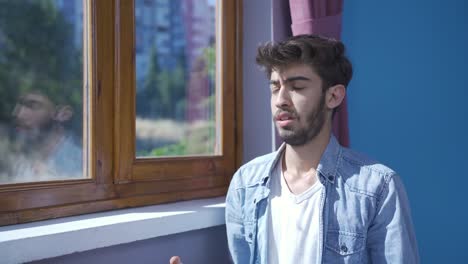 Muslim-man-praying-in-front-of-the-window.