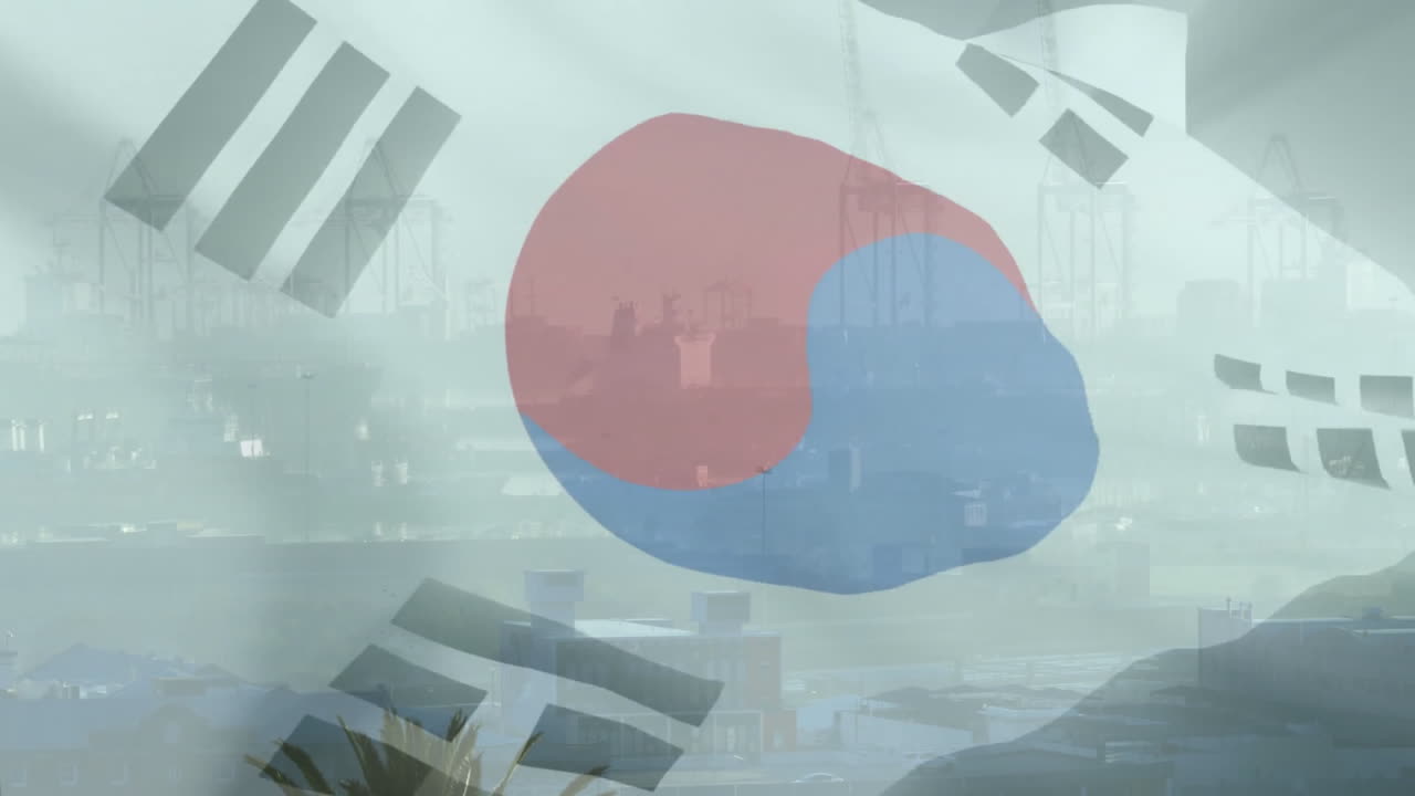 South Korean flag waving over industrial port with cranes and buildings