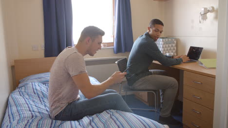 Male-Students-Working-In-Bedroom-Of-Campus-Accommodation