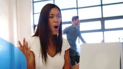 shocked business executive looking at laptop