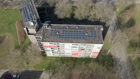 jib down of solar panels on large apartment building rooftop