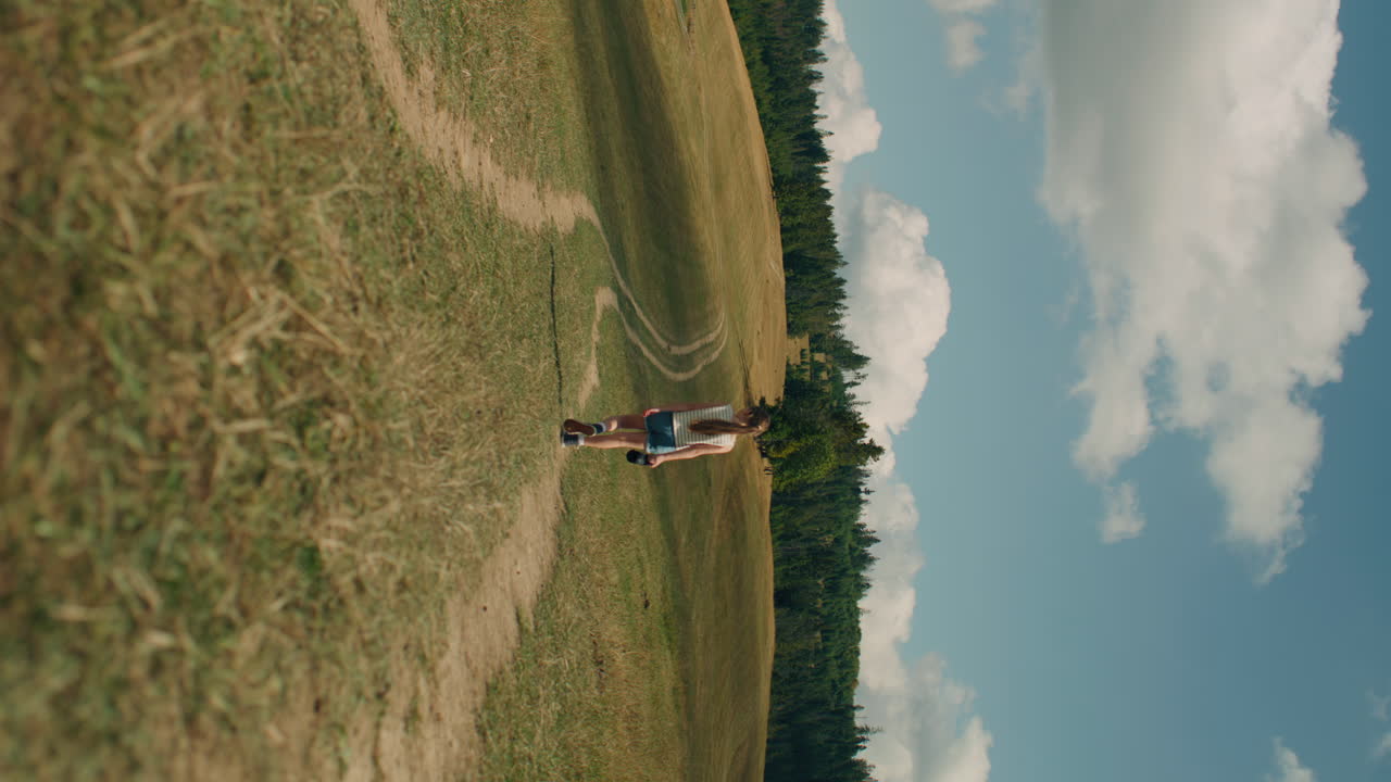 Young Girl Photographer Walking with Camera Young Photographer Walking with Camera on Grass Hill Girl Watching at Beautiful Landscape and Amazing Nature View Spending Leisure Time Outdoor Slow Motion front View
