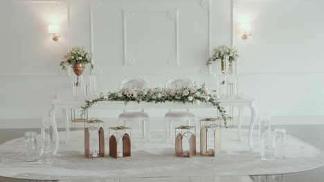 romantic white wedding reception table with flowers and lanterns