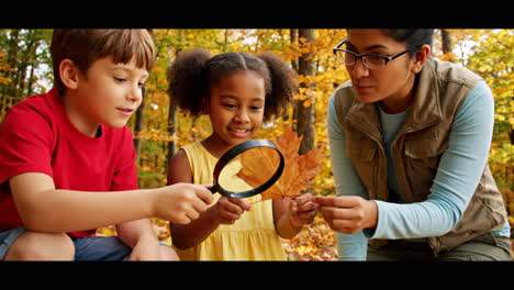 children and adult exploring autumn leaves with magnifying glasses