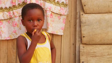 close-up-of-African-black-young-children-kid-eating-in-small-remote-rural-village-of-Ghana-Africa,-portrait-of-children