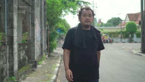 man walking outdoors on a hot day