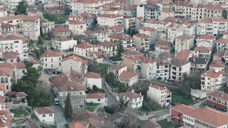 A-drone-shot-of-village-mountain,-warm-weather,-flying-backwards-of-a-dreamy-town-hill,-4K-video,-European-spring-nature,-beautiful-landscape,-scenic-clear-water-lake