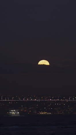 full moon over city at night