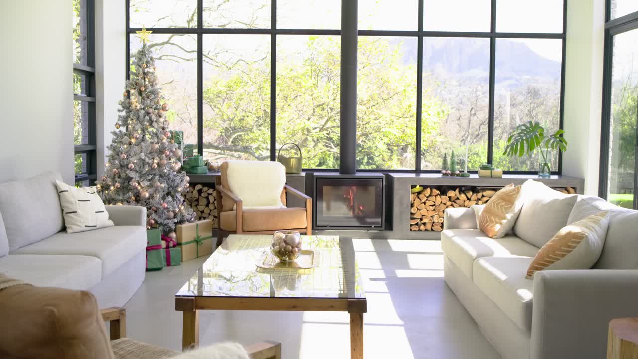 Camera starting from static sunlit room is panning right downward to reveal cozy holiday interior