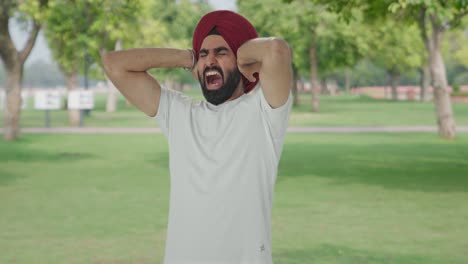 angry sikh indian man challenging someone for fight in park