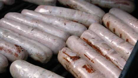 fresh pork sausages cooking on bbq