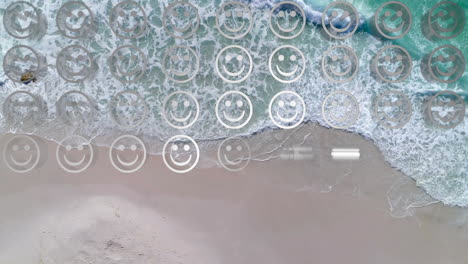 digital composition of rows of multiple smiling face emojis against against aerial view of the beach