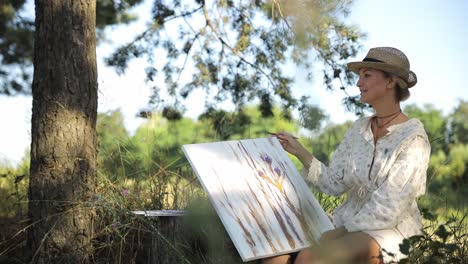 artist girl paints a picture in the forest girl enjoy solitude with nature