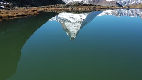 ascending shot of matterhorn and blue stellisee lake