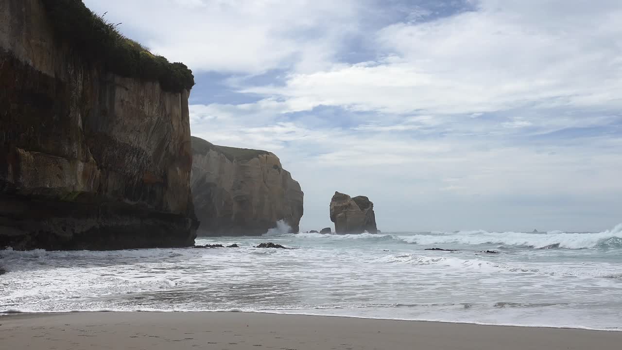 South-east shot of incoming waves and incredible coastal sandstone cliffs - Tunnel Beach Track, Dunedin