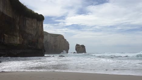 South-east-shot-of-incoming-waves-and-incredible-coastal-sandstone-cliffs---Tunnel-Beach-Track,-Dunedin