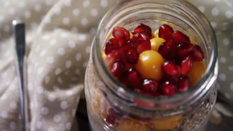 yogurt with pomegranates and golden berries in glass jar 4k