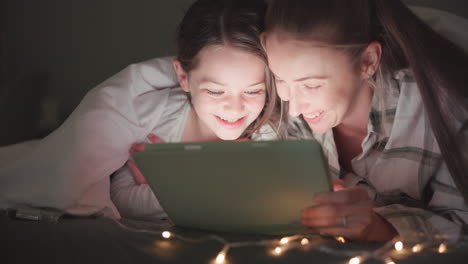 tableta, noche y madre con la hija en el dormitorio