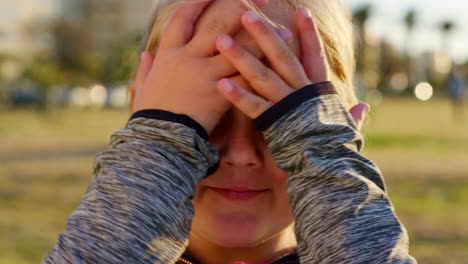 child, nature and hands on face putting hair to