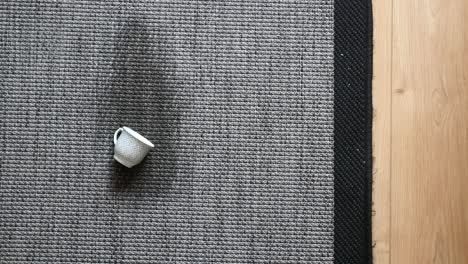 small porcelain cup on gray carpet