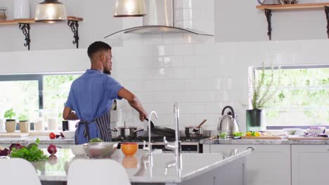 african american man preparing meal in kitchen