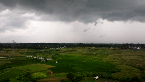 dark stormy clouds above paddy fields during rainy season in bali, indonesia