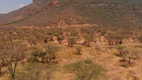 motorbike driving next to the sacred samburu mount ololokwe in northern kenya