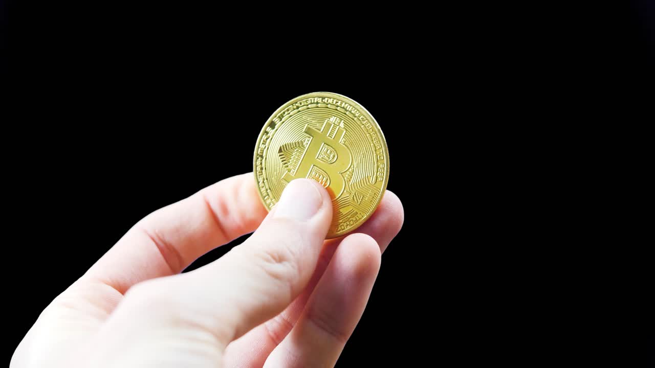 business investor hand holding a crypto coins cryptocurrency digital currency Btc Bitcoin investment concept black studio background