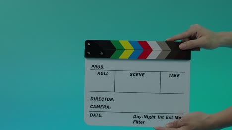 clapperboard hitting. film film slate. close up hand clapping empty film slate on blue or green screen color background. in and out film slate cutting for video production. film o film shooting.