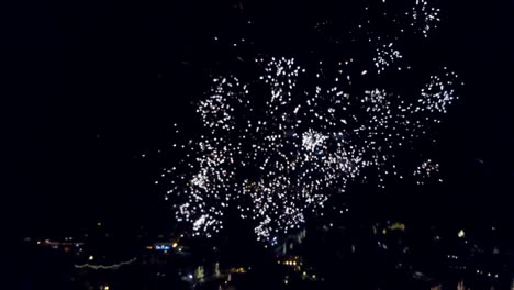 fireworks explode over aerial view