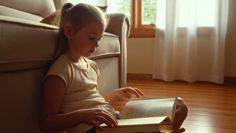 a girl reading a book at home