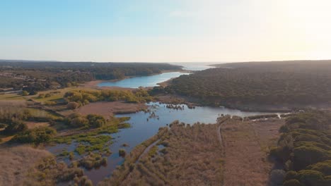 Flying-Over-Distinctive-Albufeira-Lagoon-Under-Sunlight,-Portugal