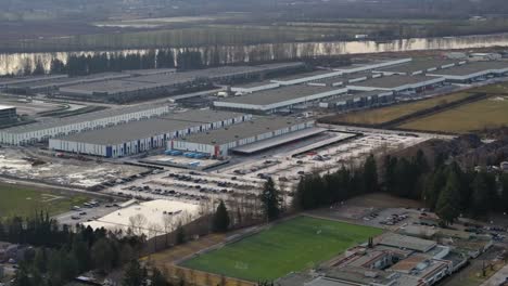 big riverside logistics center and warehouses aerial view - daytime