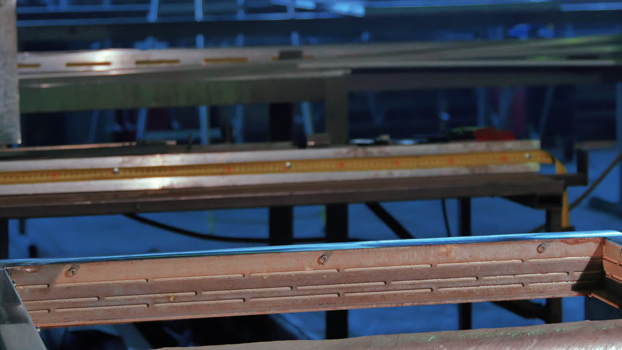 제조 시설에서 금속 부품을 다루는 노동자