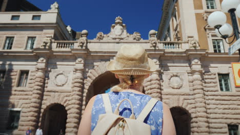 Stockholm-Sweden-A-Female-Tourist-With-A-Swedish-Flag-Goes-To-The-Arch-Near-The-Parliament-One-Of-Th