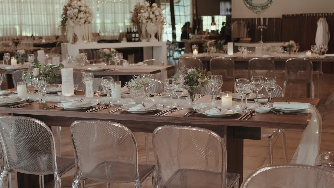 Beautifully decorated wedding dining tables with flowers and candles