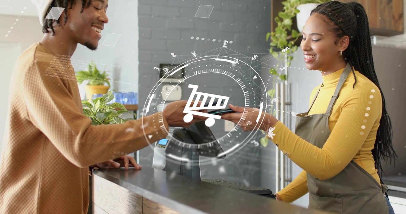 Aligning phones, customer and cashier tapping POS at cafe counter, in yellow top, grey apron