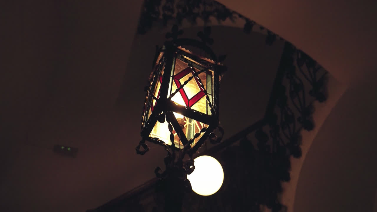Antique Stained Glass Lantern Hanging in Dark Interior