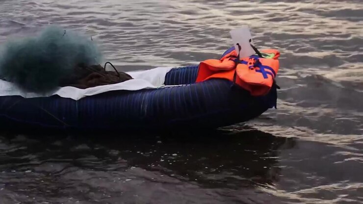 Small rubber boat floats on the surface of Rancabuaya beach, Garut, West Java, Indonesia