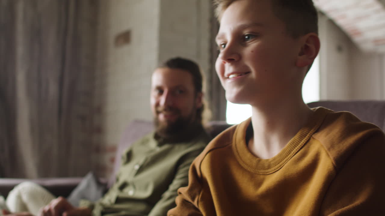 Caucasian man and boy in the living room